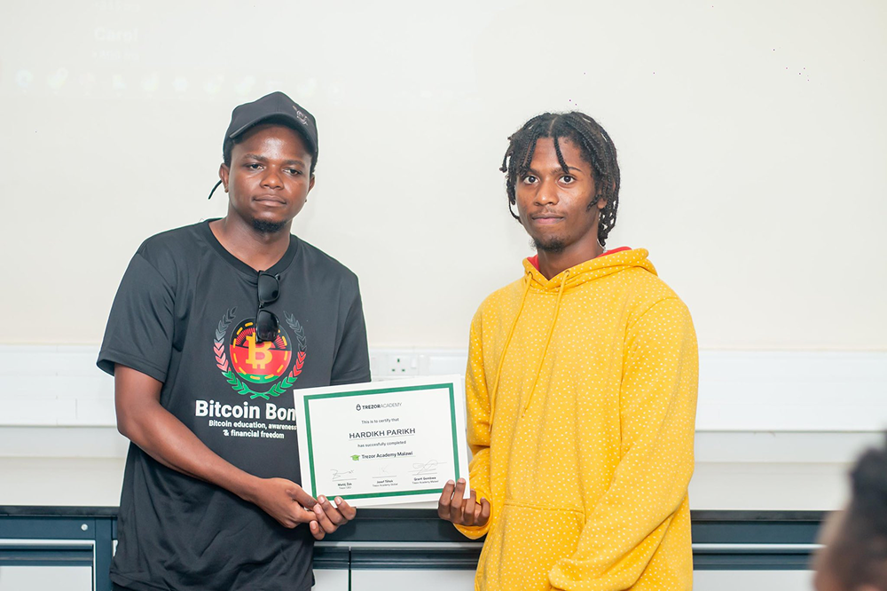 Bitcoin Boma participants receiving Trezor hardware wallets and certificates at UNIMA Bitcoin Education Program March 2026