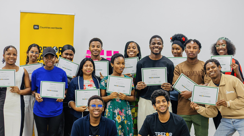 Trezor Academy graduates in Mauritius holding completion certificates after Bitcoin education sessions.